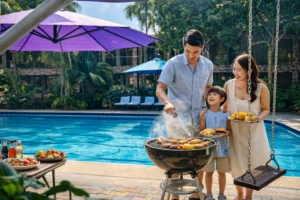 Happy family grilling food beside the swimming pool during an outdoor gathering at Wondellea Cafe & Resort, Silang Cavite.