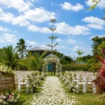 An elegant outdoor floral arrangement and guest seating setup for a beautiful garden wedding reception at Wondellea