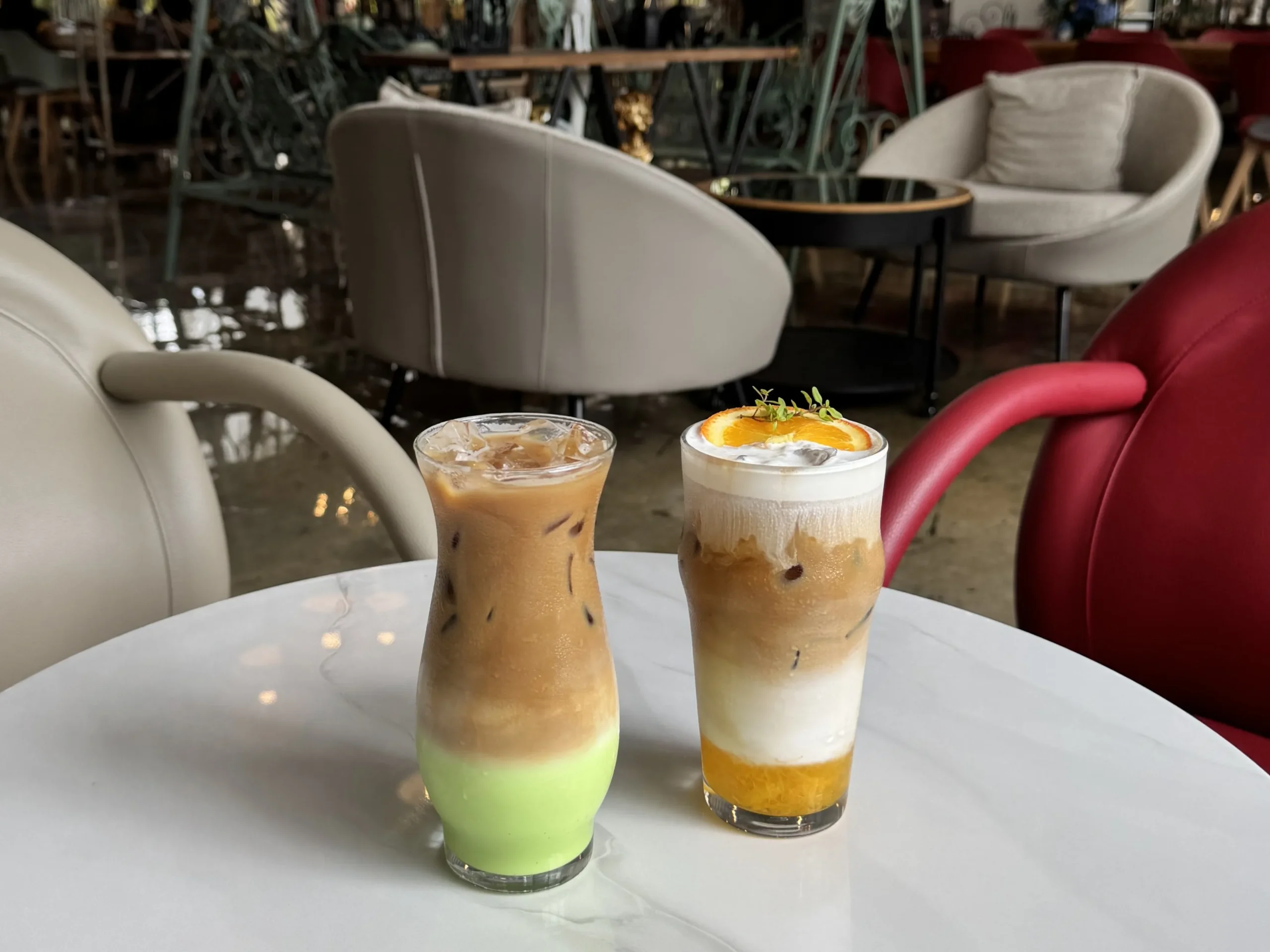 Two refreshing iced drinks served at a coffee shop near me open with cozy indoor seating