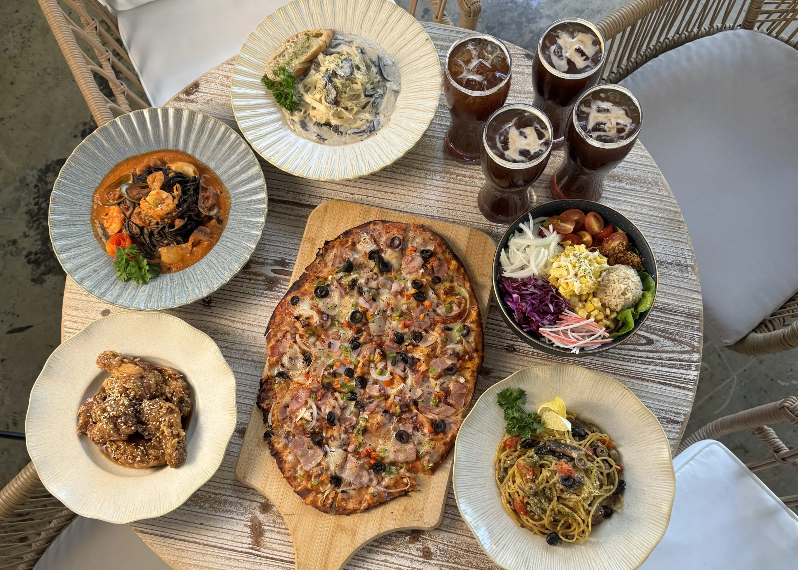 Wondellea Cafe Menu spread with pizza, pasta, wings, salad, and iced drinks