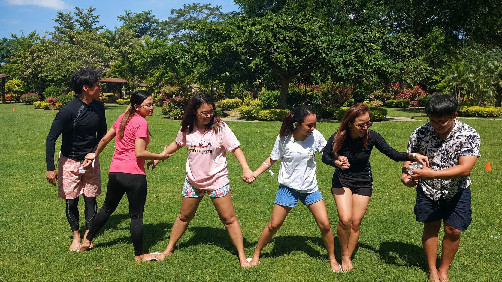 Group team-building activity at an event place in Cavite with pool and spacious lawn.