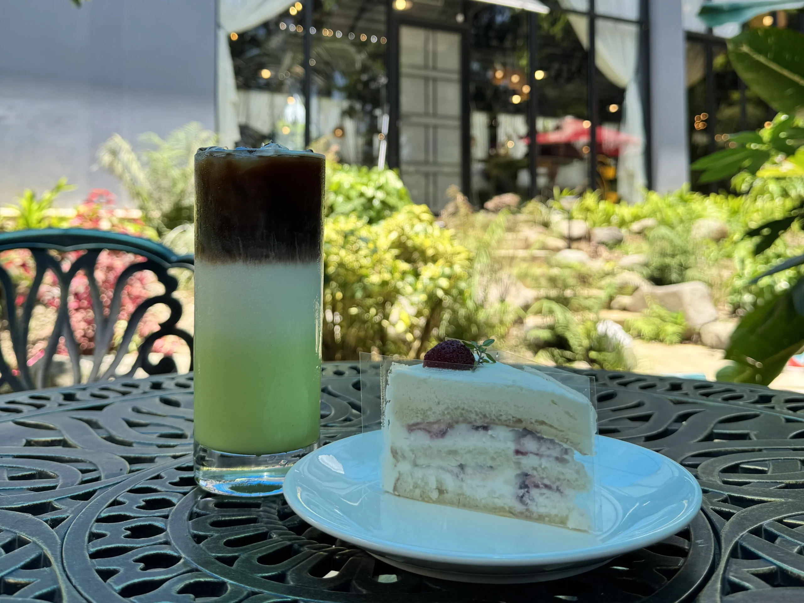 Iced coffee and cake enjoyed at an outdoor cafe in Cavite garden setting