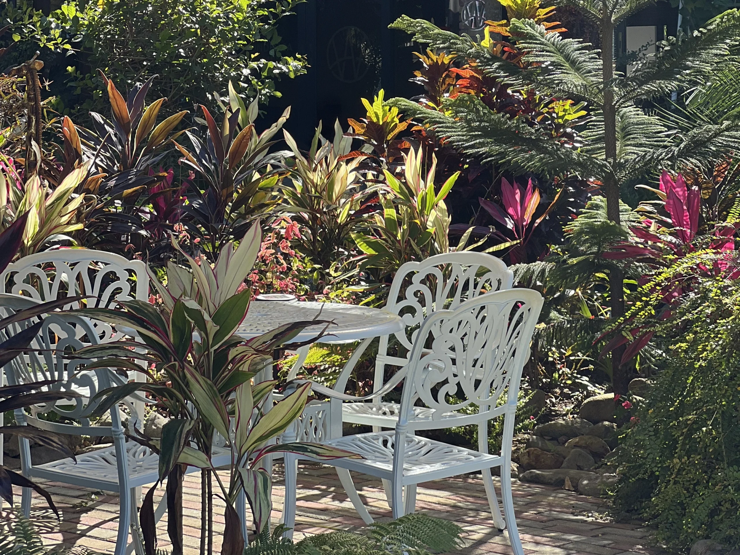 White garden tables and chairs at an outdoor cafe in Cavite